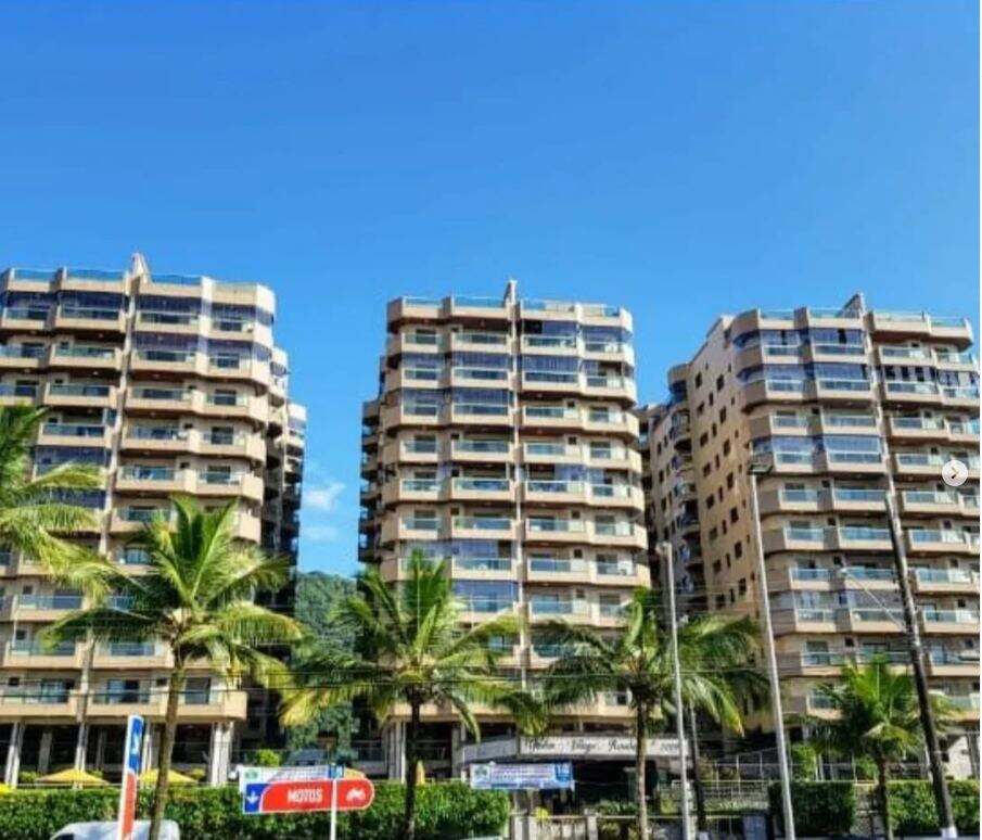 Fachada de empreendimento residencial de alto padrão, com vista para o mar e área com palmeiras